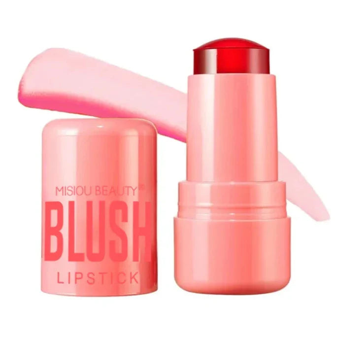 Blush crème rose en bâton dans un tube cylindrique avec le texte ’BLUSH’ sur l’emballage.