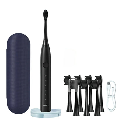 Brosse à dents électrique noire avec base de chargement, étui de voyage et têtes de brosse de rechange.