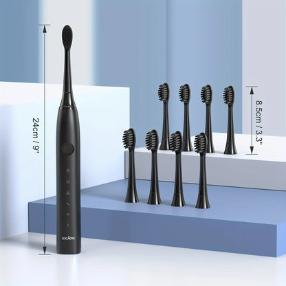 Brosse à dents électrique noire avec plusieurs têtes de brosse de rechange.