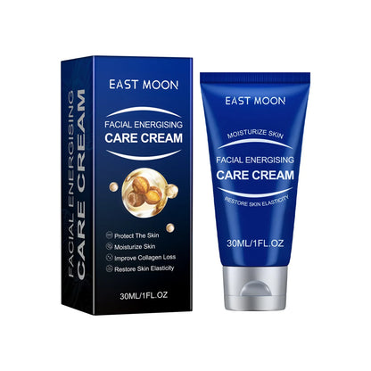 Crème de soin énergisante pour le visage East Moon dans un emballage bleu avec sa boîte de produit.