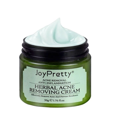 Pot vert de JoyJolie crème à base de plantes pour éliminer l’acné, avec un produit couleur menthe visible sur le dessus.