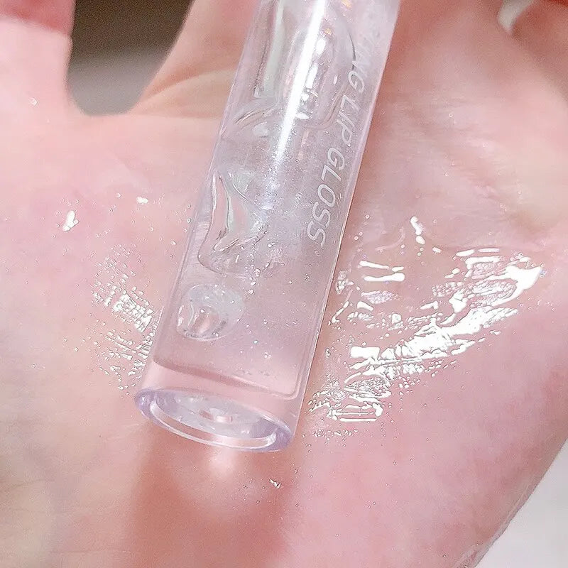 Tube en verre ou en plastique transparent portant des inscriptions.