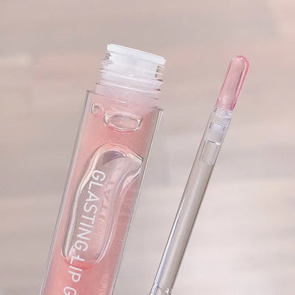 Tube de gloss rose avec applicateur.