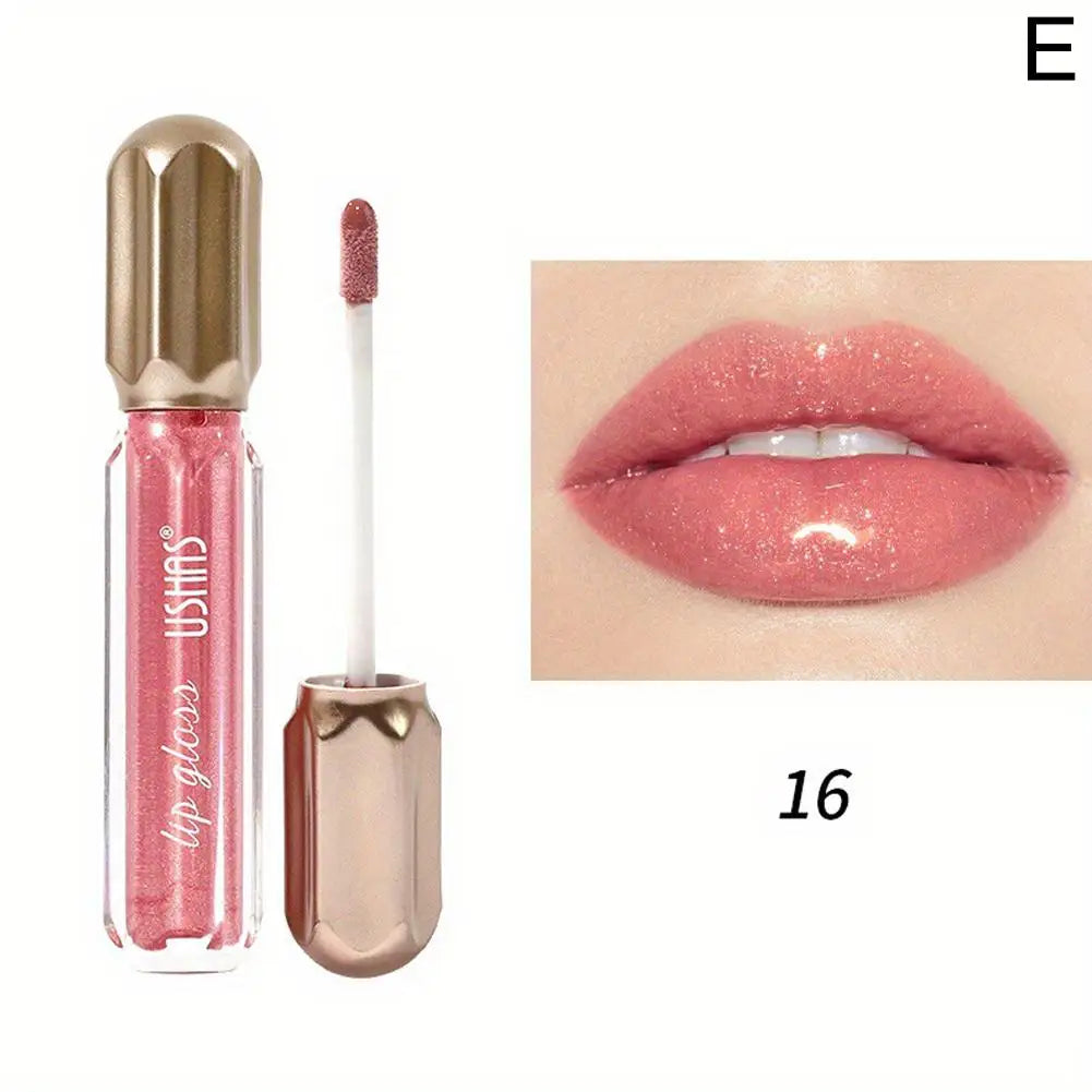 Gloss rose dans un tube transparent avec un bouchon doré et un applicateur.