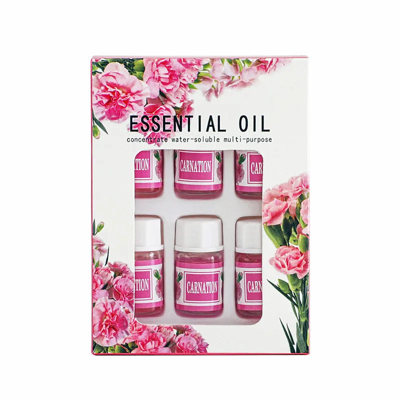 Coffret d’huiles essentielles étiquetées en rose dans un emballage floral avec des éléments décoratifs en forme d’œillet.