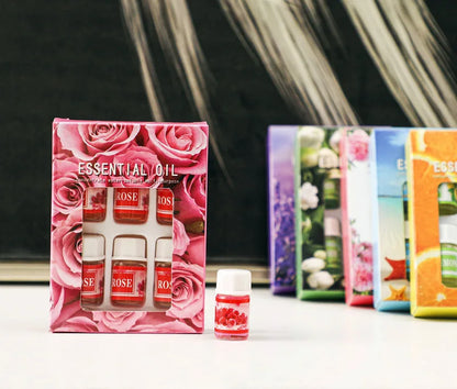 Coffret d’huiles essentielles sur le thème de la rose avec petits flacons en verre.