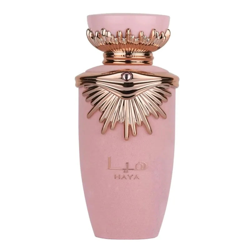 Flacon de parfum rose avec un motif en forme de soleil doré et une couronne décorative.