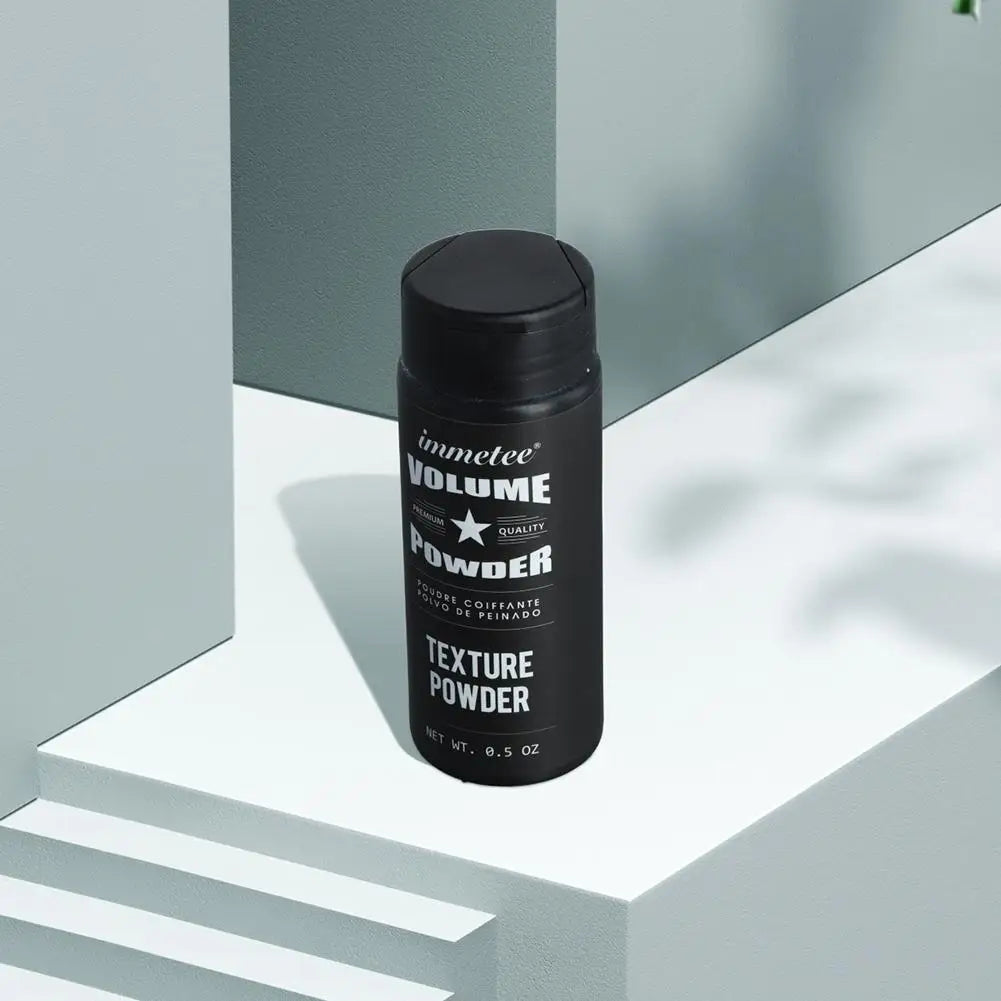 Flacon noir de poudre de texture volumineuse pour la coiffure.