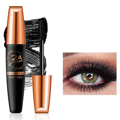 Tube de mascara noir et cuivré avec brosse applicatrice.