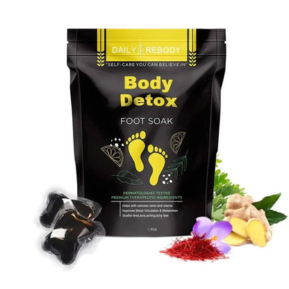 Pochette noire de bain de pieds body detox avec texte jaune et motif d’empreinte de pied.