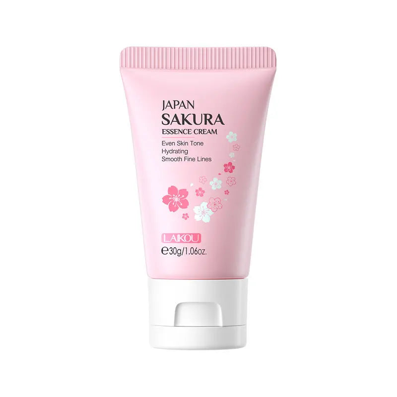 Tube rose de crème d’essence japonaise Sakura avec des motifs de fleurs de cerisier.